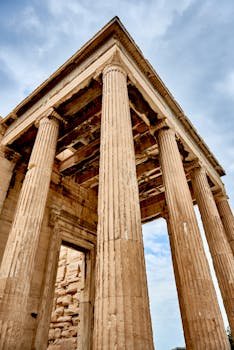 Low angle view of an ancient Greek temple's columns in Athens, showcasing historic architecture.